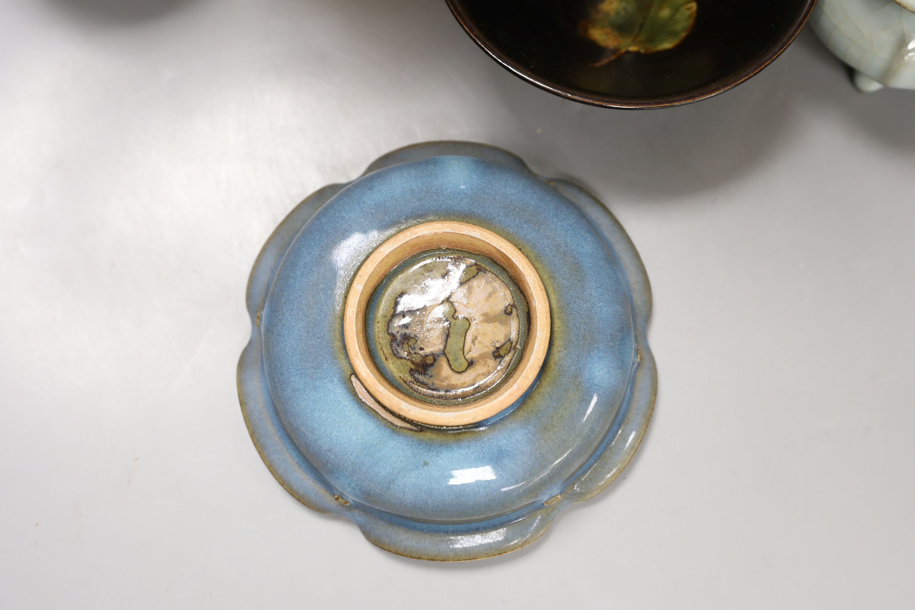 A group of Chinese monochrome ceramics, comprising two crackle glaze vases, tallest 21 cm, one cased, a Jun type dish and tripod censer a leaf impressed bowl and another bowl